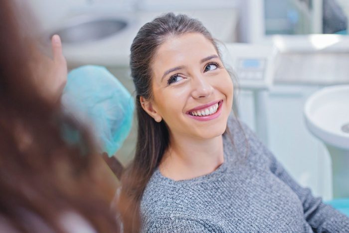 woman smiling in dental chair botox treatment dentist in Chevy Chase Maryland
